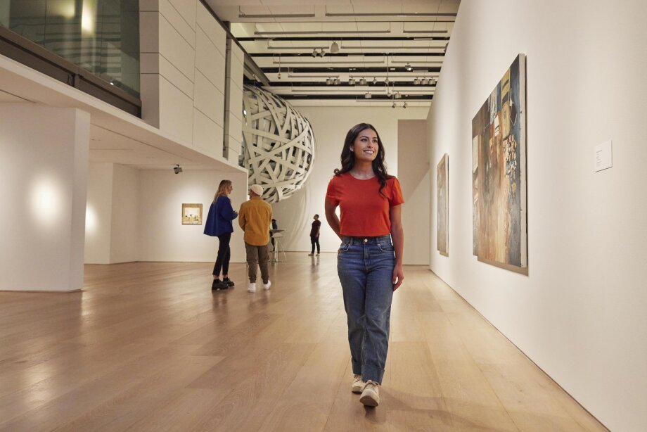 Woman walking through an exhibit at Esker Foundation