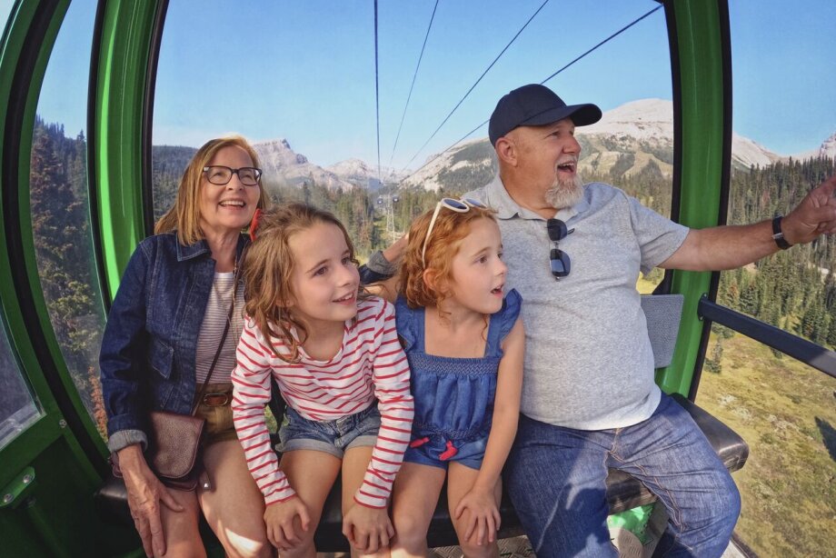 Older couple with young kids riding in the gondola.