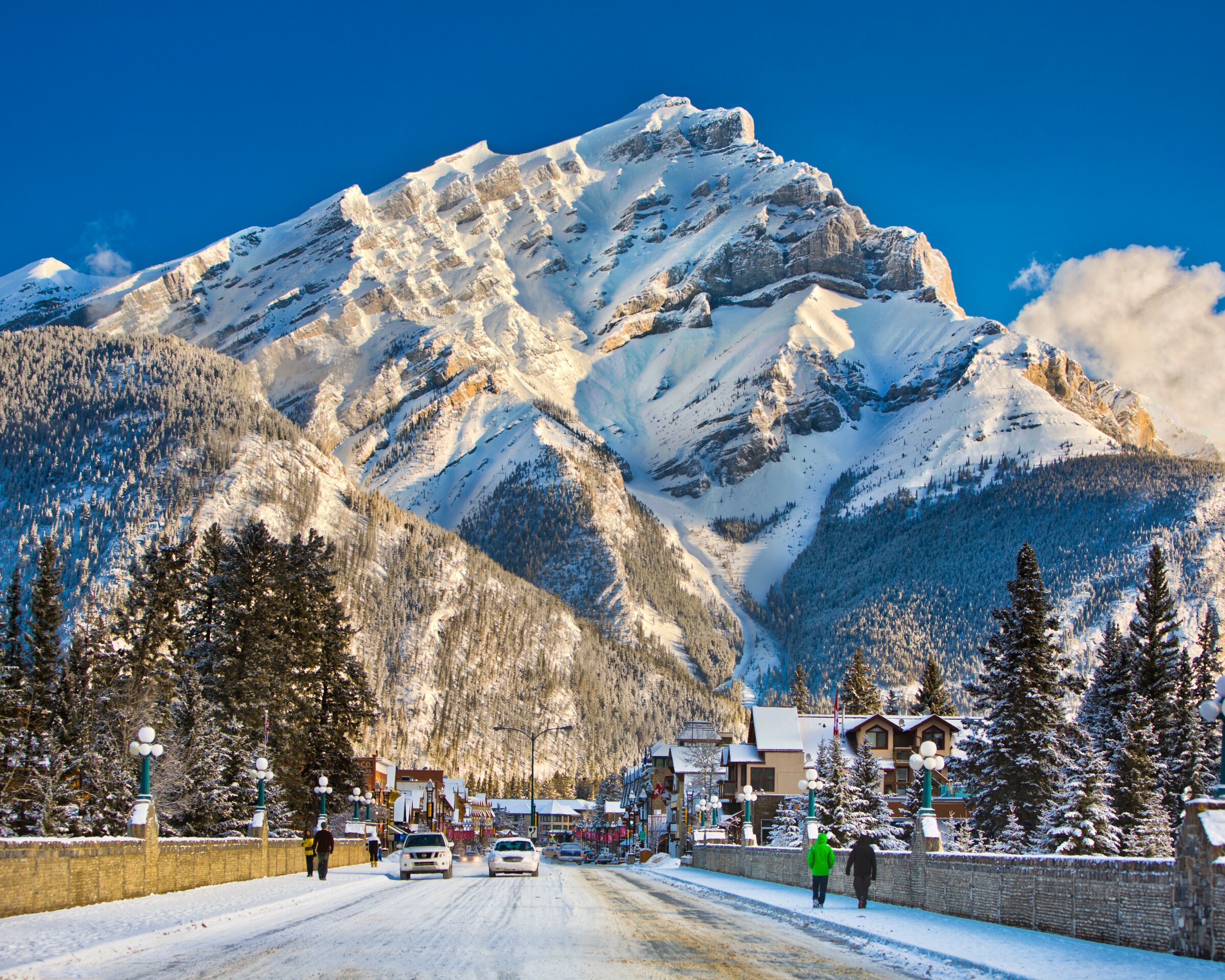Postcard picture of Banff looking downtown with majestic rugged mountain as the backdrop in Banff National Park