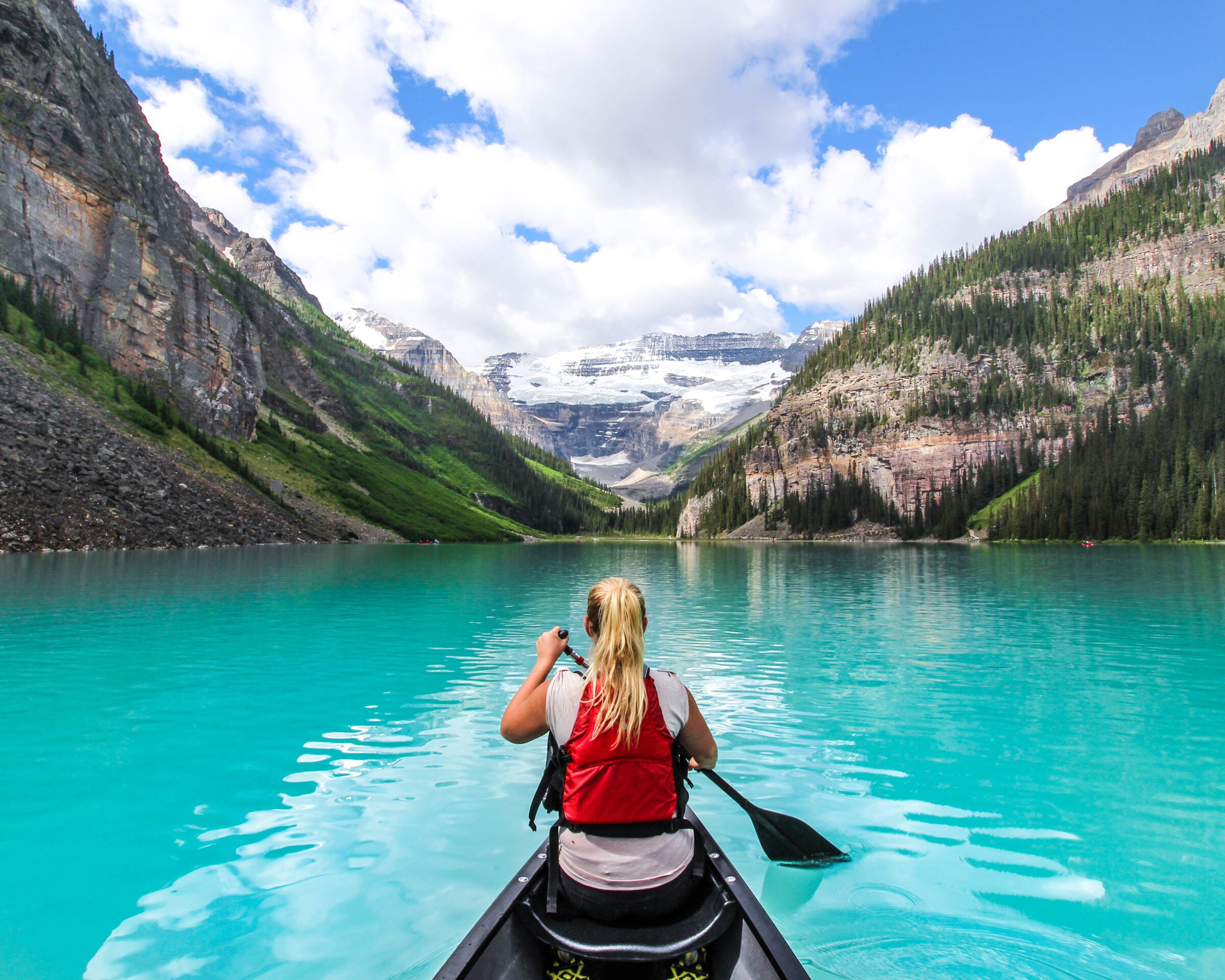 Scenic shot of women canoeing on Lake Louise