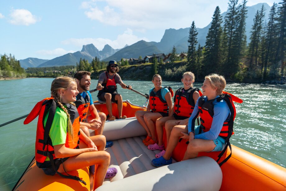 A family heads out on Canmore Raft Tours with a guide down the Bow River