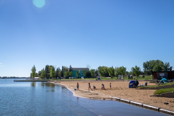 Families enjoying the beach on Chestermere Lake.