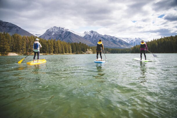 A group of three women SUP on Johnson Lake.