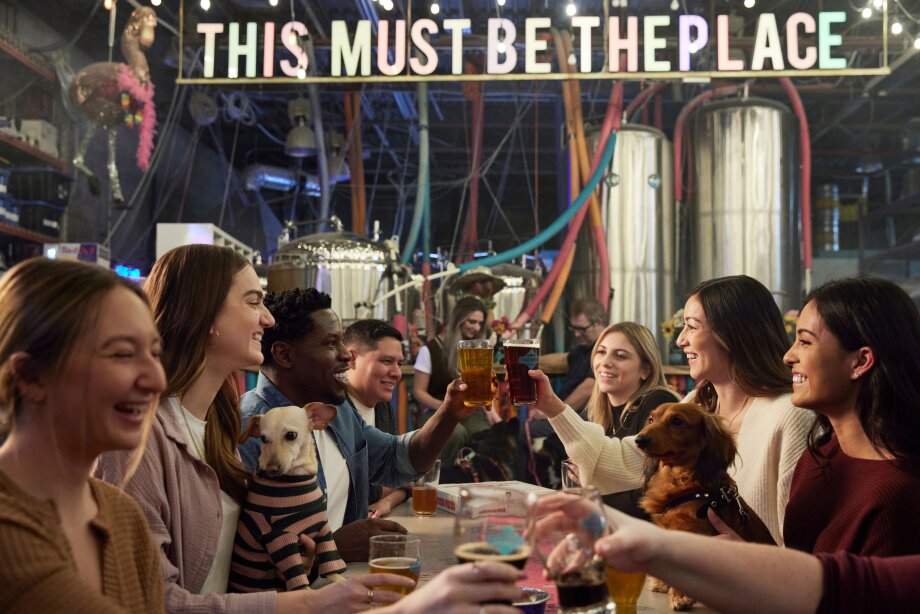 Group of friends cheers-ing beers at Cold Garden Brewery