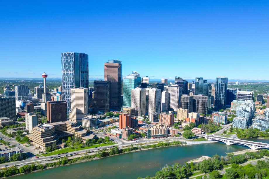 Aerial view of the Bow River and Calgary skyline in spring.