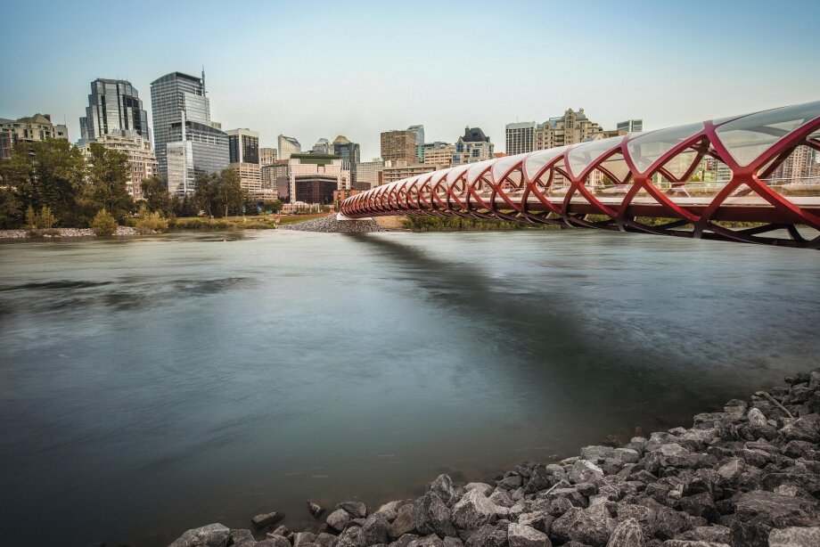 A landscape view of the Peace Bridge crossing the Bow River.