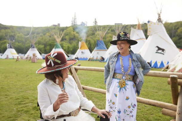 Two indigenous women chatting at the Elbow River Camp