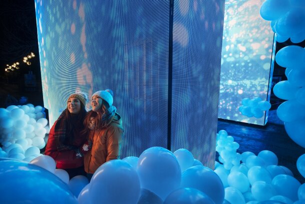 Two friends enjoy the Andap chinook arch with balloon installation at Chinook Blast 2021