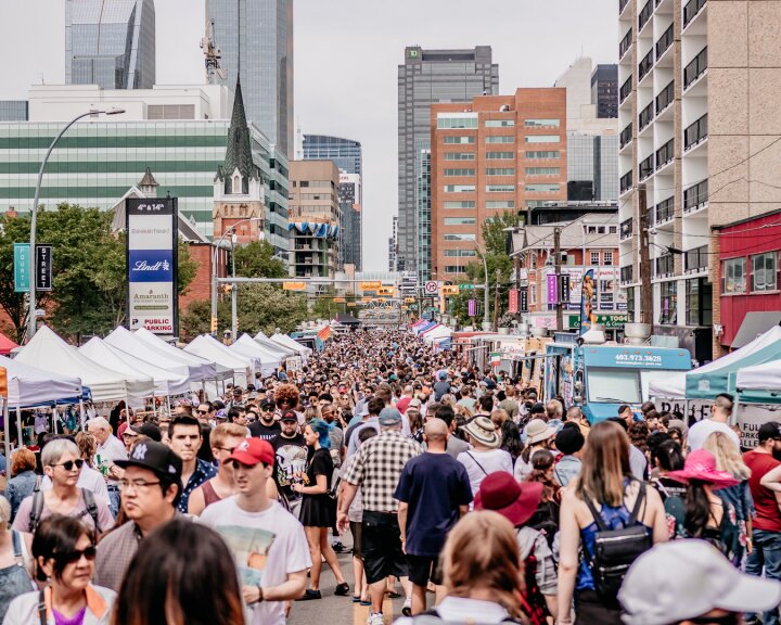 large crowd exploring vendors on 4th street during Lilac Festival