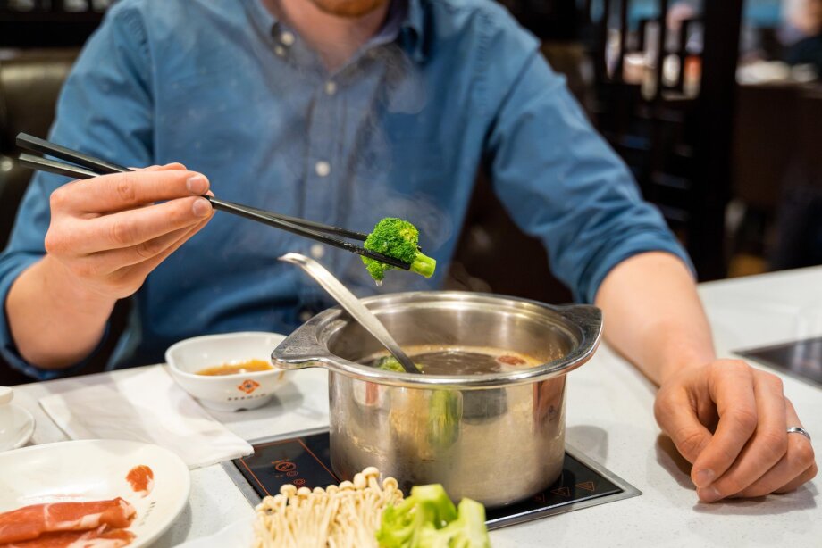A man enjoys steaming hot pot at Chine Hot Pot Restaurant,