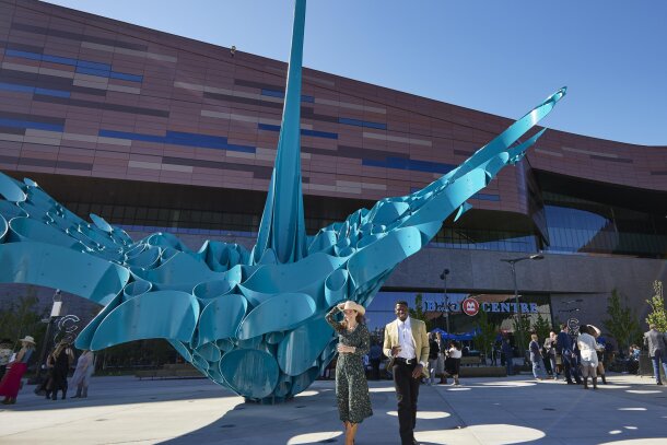 Two people walking in front of the BMO centre