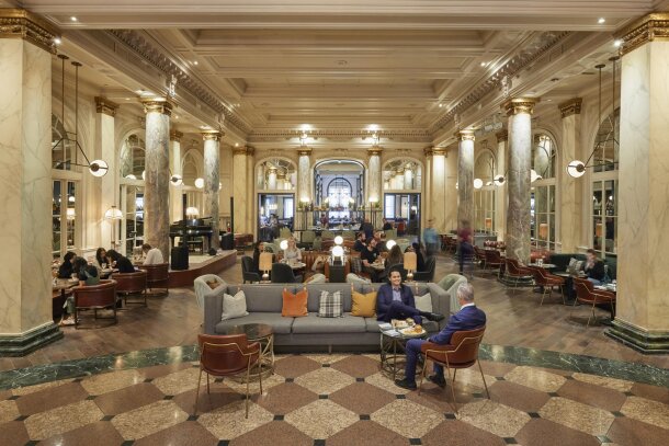 Two business people hanging out on the lobby couches at the Fairmont Palliser Hotel.