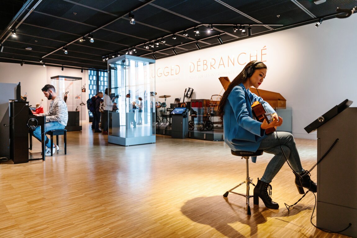 People playing instruments at Studio Bell exhibit.