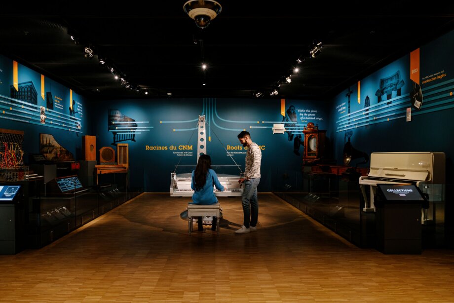 couple interacting with musical instrument exhibits at Studio Bell