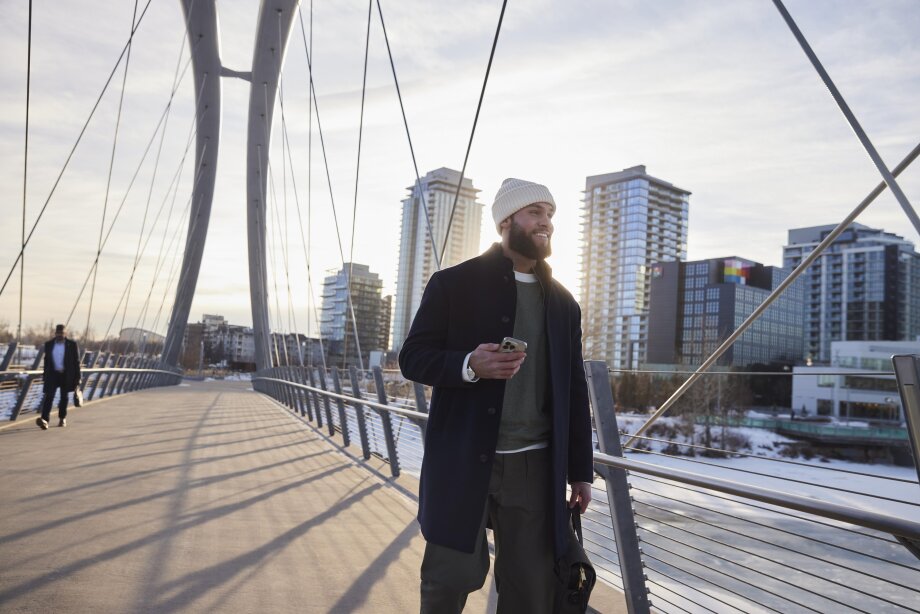 Man walking across bridge in east village