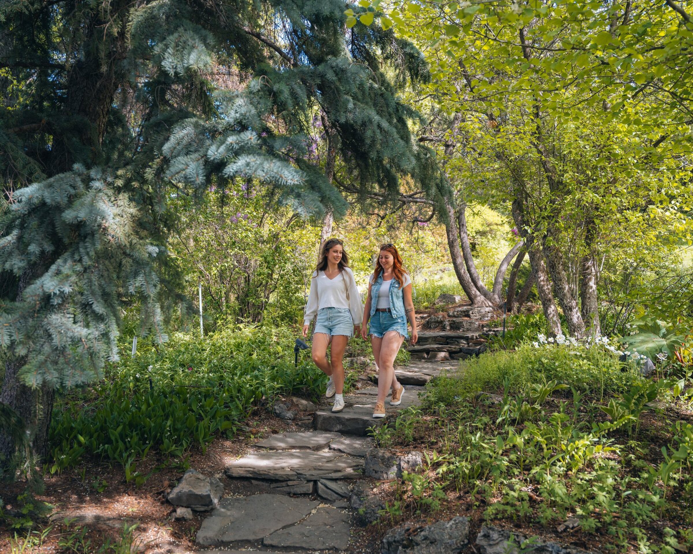 Two women walking down a stone pathway at Reader Rock Garden.