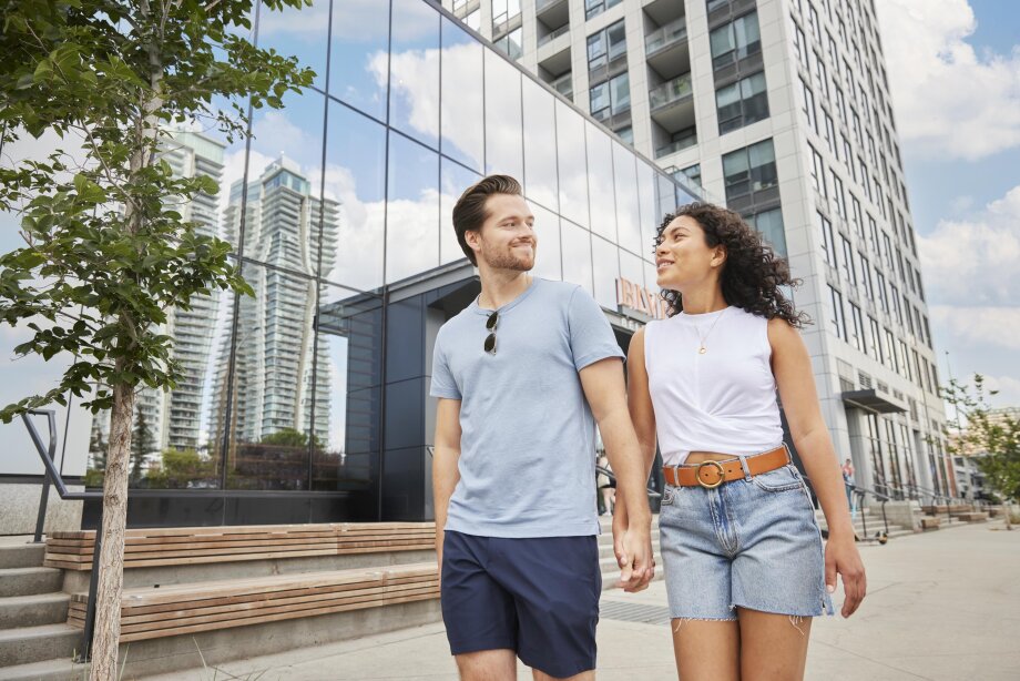 couple walking and holding hands downtown