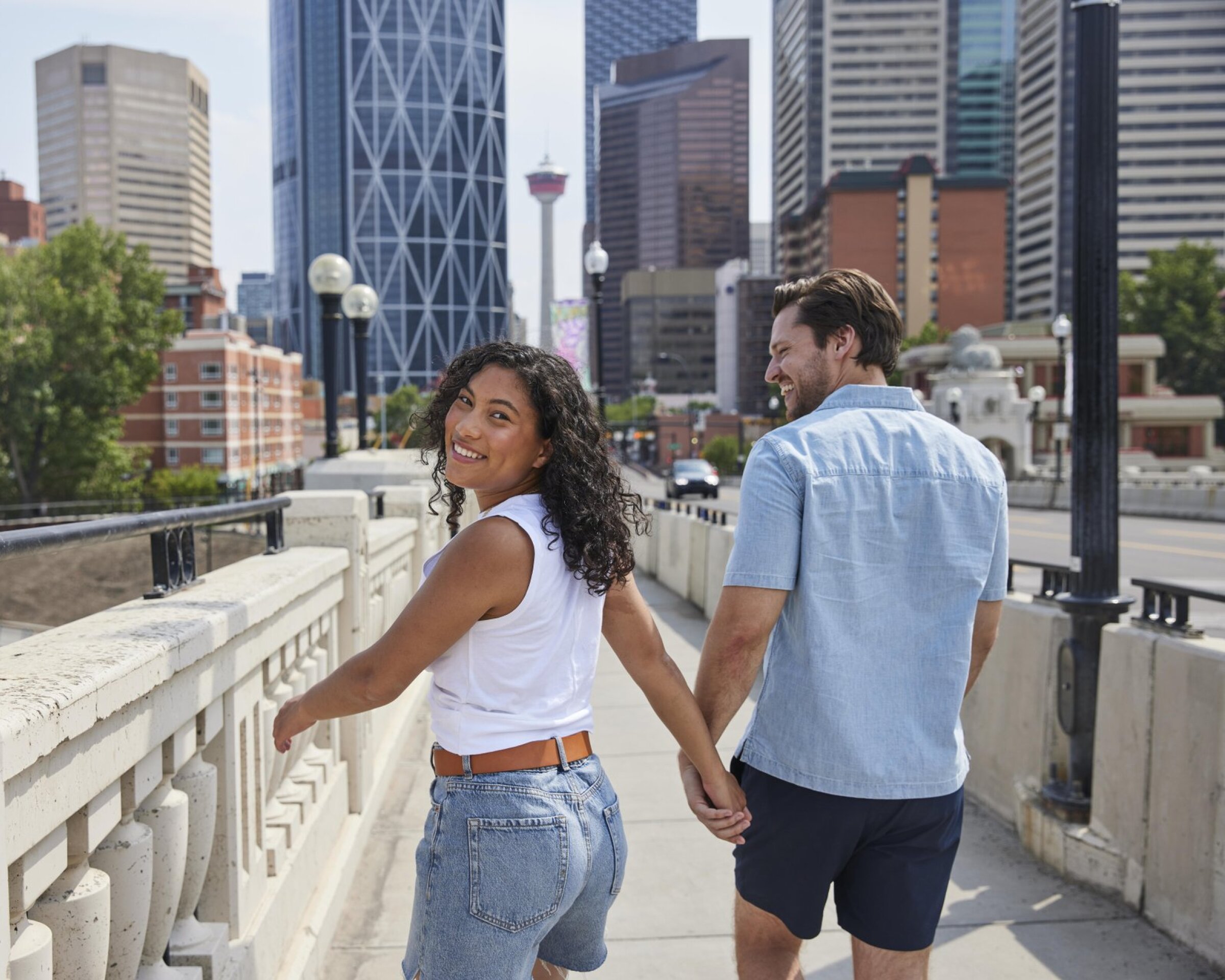 A couple walking hand in hand on Centre Street Bridge