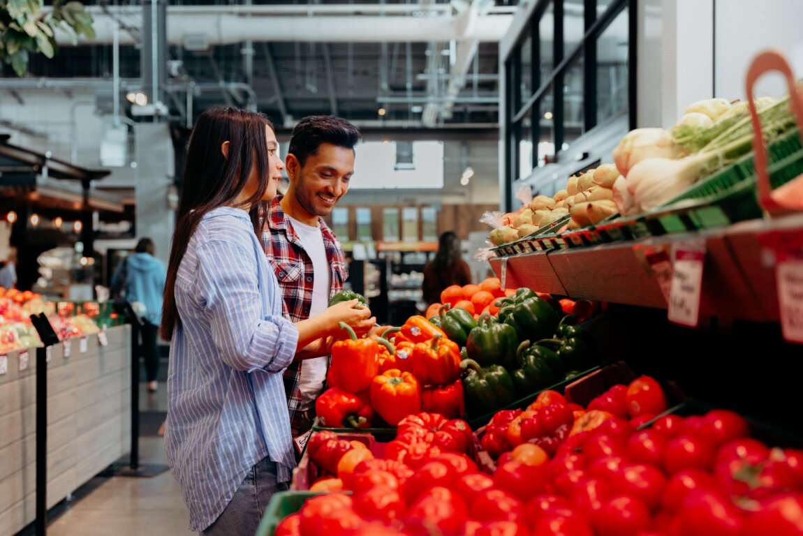 Two people looking for produce at the Calgary Farmer's Market West.