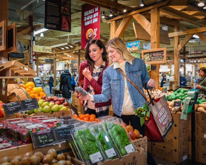 two ladies picking out produce at Calgary Farmers Market South