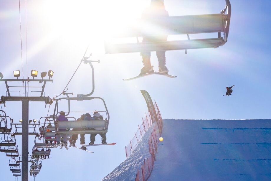 Skier riding a chairlift at WinSport