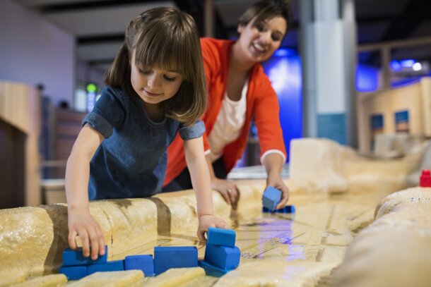 Family interacting with the Earth and Sky Gallery at the Telus Spark Science Centre in Calgary