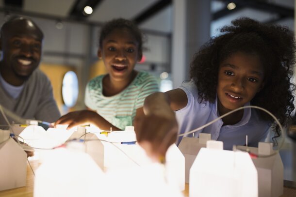 Family interacting with the Energy and Innovation Gallery path Telus Spark Science Centre in Calgary