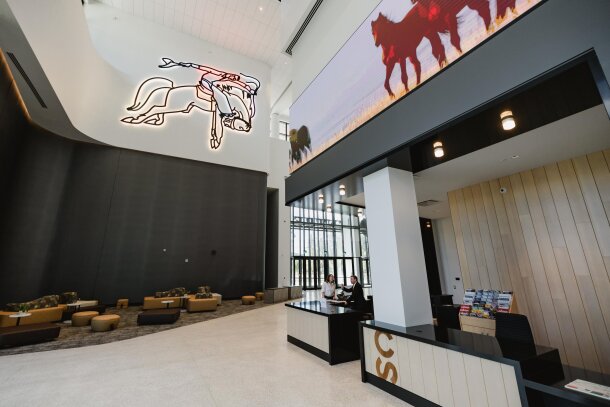 Neon cowboy on the wall of BMO Centre