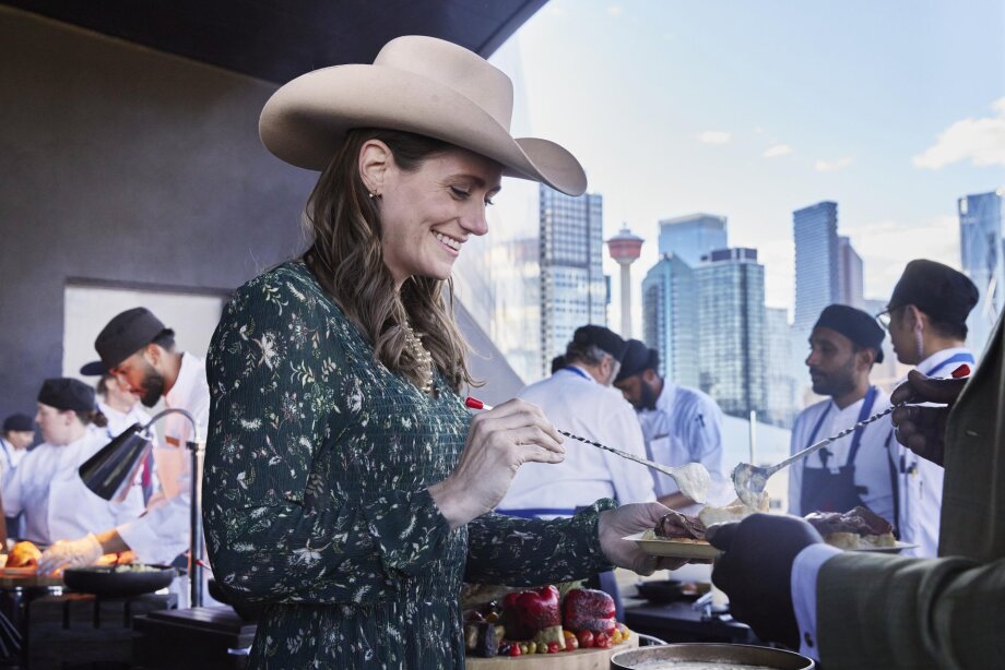 A woman takes part in a buffet on the patio at the BMO Centre.