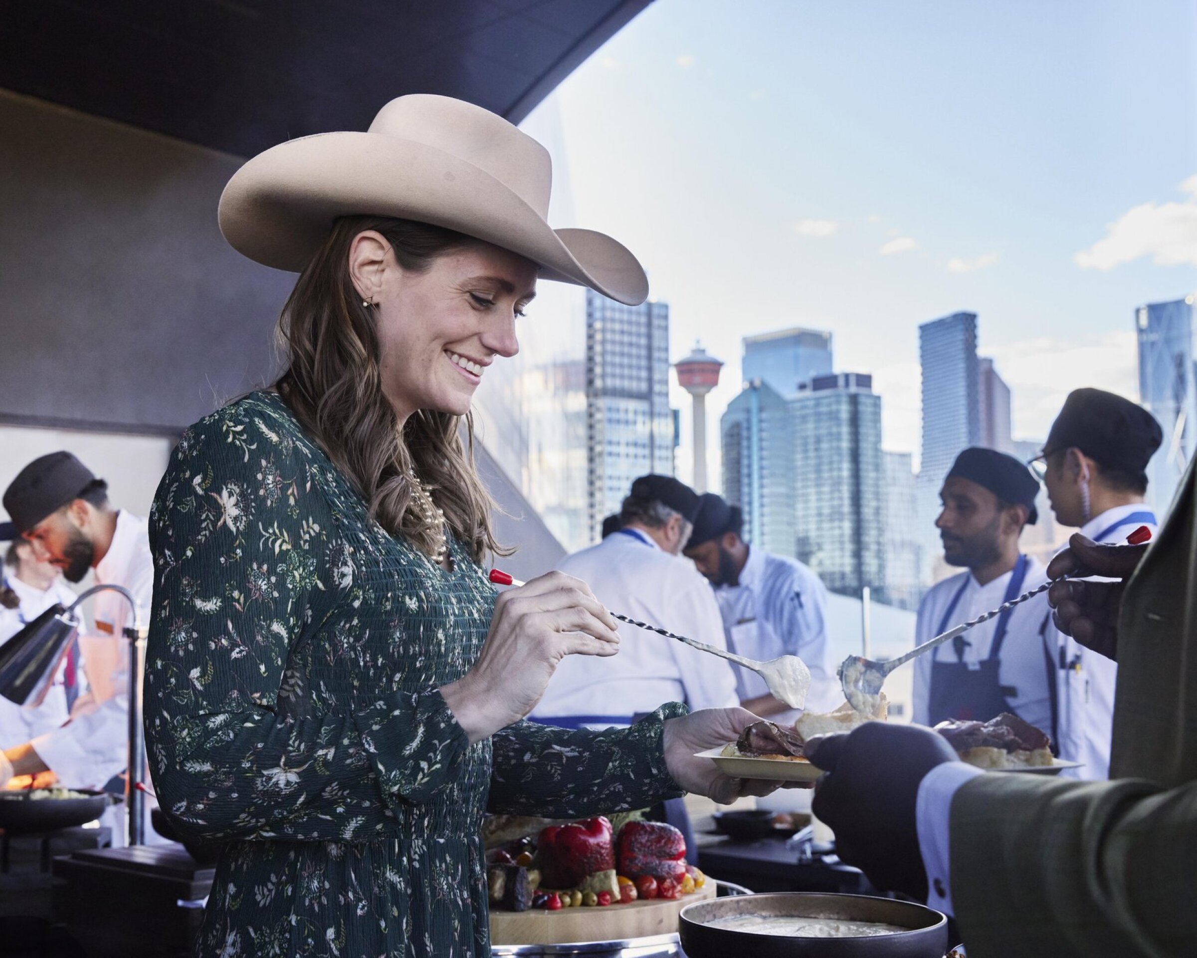 A woman takes part in a buffet on the patio at the BMO Centre.